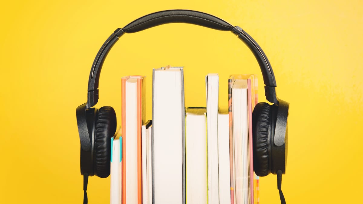 Audible Review Headphones Sitting Over the Top of Books