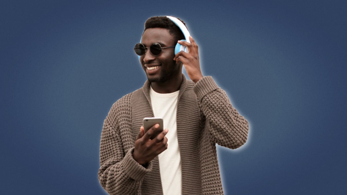 Best Podcasts for Men African American Man Smiling While Wearing Headphones and Phone