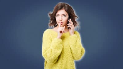 2021/04/Cheating-Girlfriend-Girl-in-yellow-sweater-on-phone-making-shh-noise.jpg