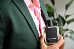 2019/09/Cologne-for-Men-Male-Model-Wearing-Charcoal-Suit-With-Pink-Shirt-And-Holding-Hawthorne-Play-Fragrance-Side-Angle.jpg