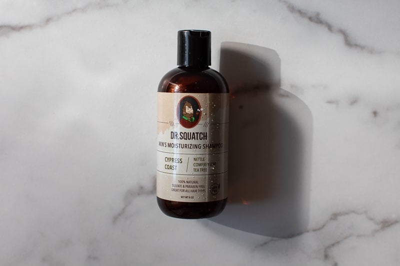 Dr. Squatch shampoo with marble backdrop