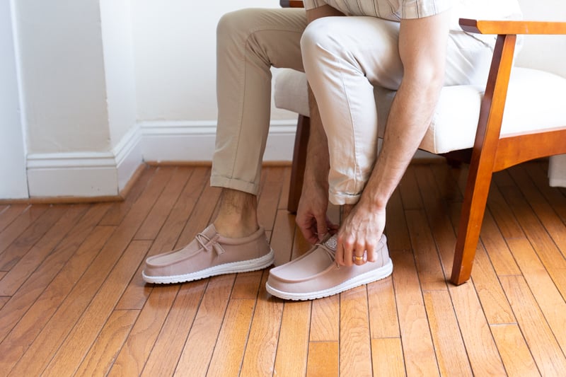 HEYDUDE Shoes Wally Slub Canvas being put on in chair