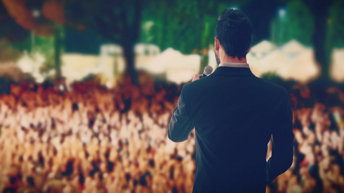 How to Improve Your Public Speaking Man in Suit Giving a Speech with Microphone at Conference