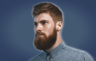 2020/09/How-to-Straighten-your-Beard-Side-on-Shot-of-a-Man-with-a-Straightened-Beard-on-Blue-Background.jpg