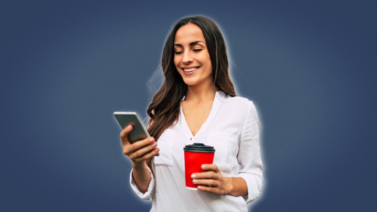 How to Text a Girl Attractive woman holding a smart phone and coffee and smiling