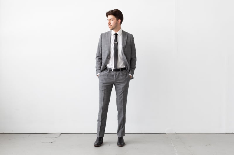 Indochino Harrogate Glen Check Suit jacket unbuttoned and hands in pockets