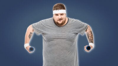 2021/09/Man-Boobs-Overweight-man-with-headband-lifting-dumbbells.jpg