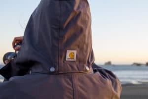 2019/07/Man-holding-camera-and-taking-photos-while-wearing-Carhartt-Shoreline-Jacket-at-the-ocean-e1593906422688.jpg