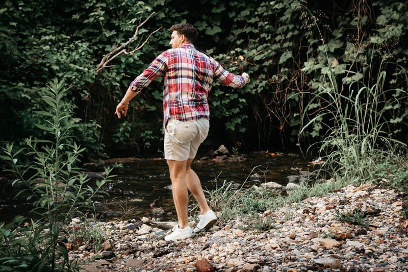 model skipping rock in jcrew madras shirt and white dock shorts 1