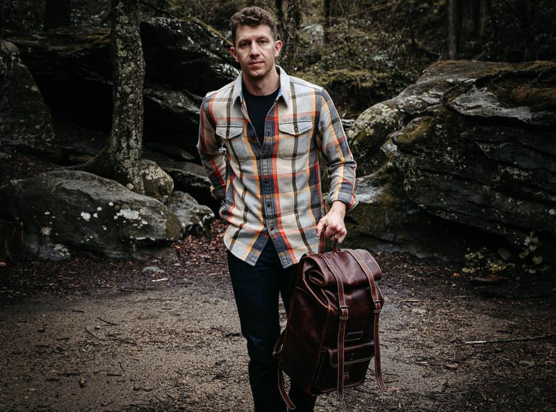 model wearing blanket shirt from outerknown with leather bag