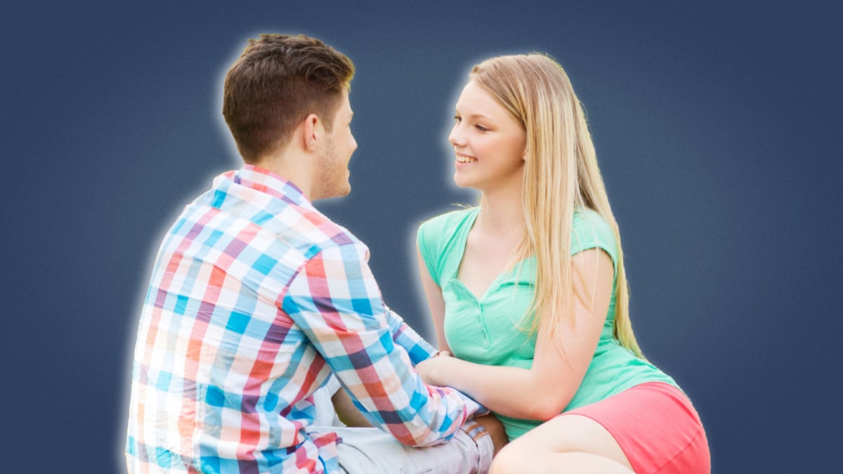 Questions to ask a girl Young couple smiling and sitting down close