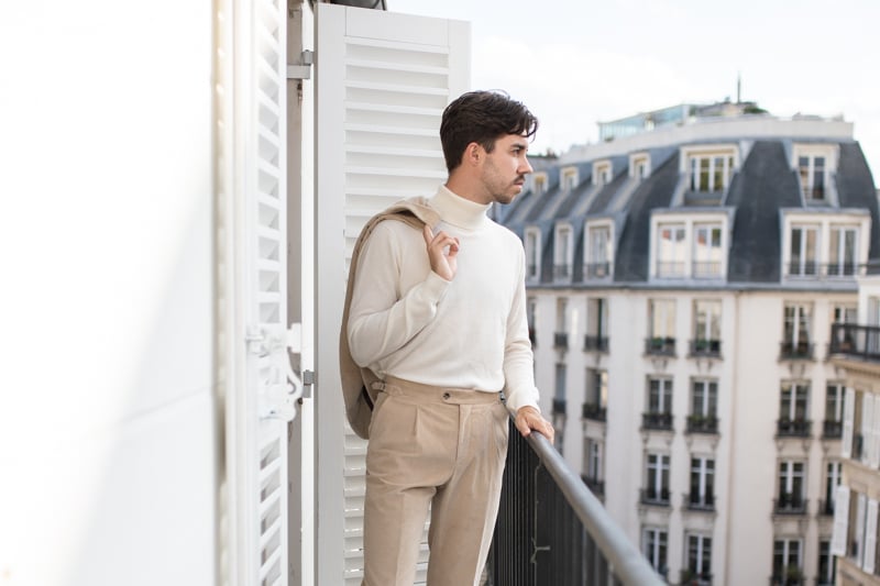 Suitsupply Custom Suit model on balcony with jacket over shoulder