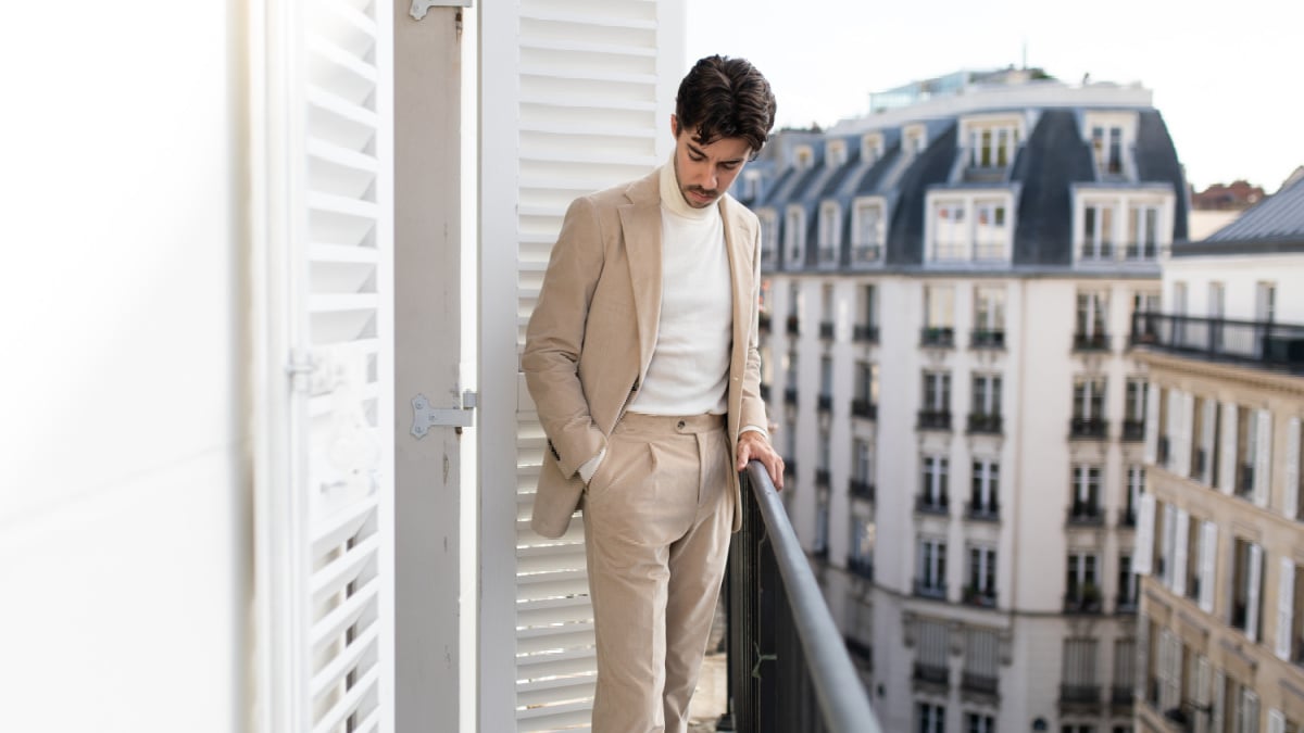 Suitsupply review Model Wearing Corduroy Suitsupply Suit Outside on a Paris balcony