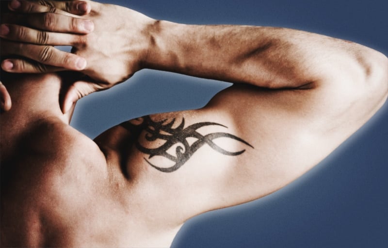 Tattoo Donts for Men Man Flexing Bicep with Tribal Tattoo on Shoulder