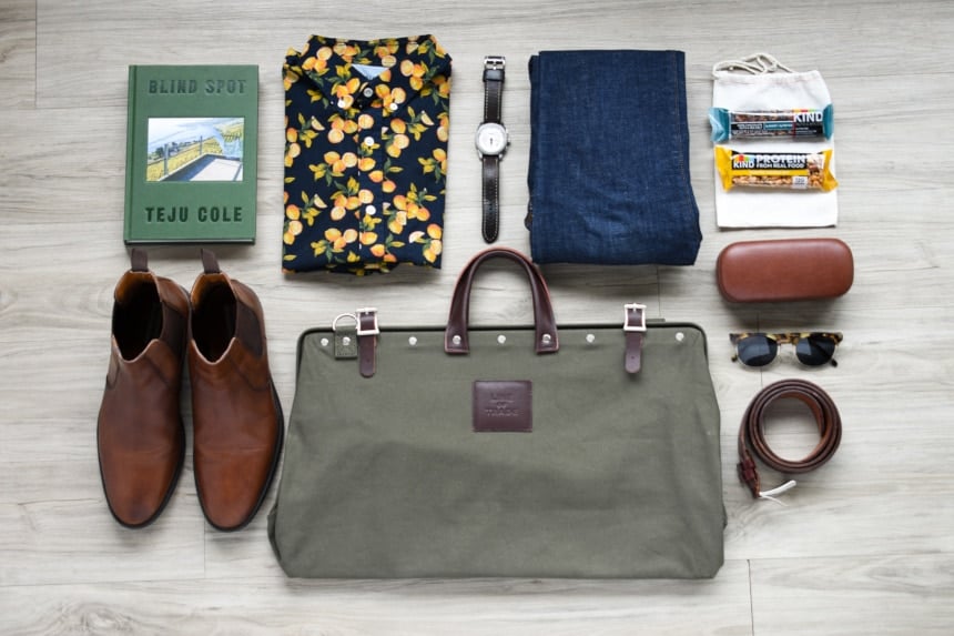 Top Down of Bespoke Post Weekender Bag and Other Unrelated Men's Accessories