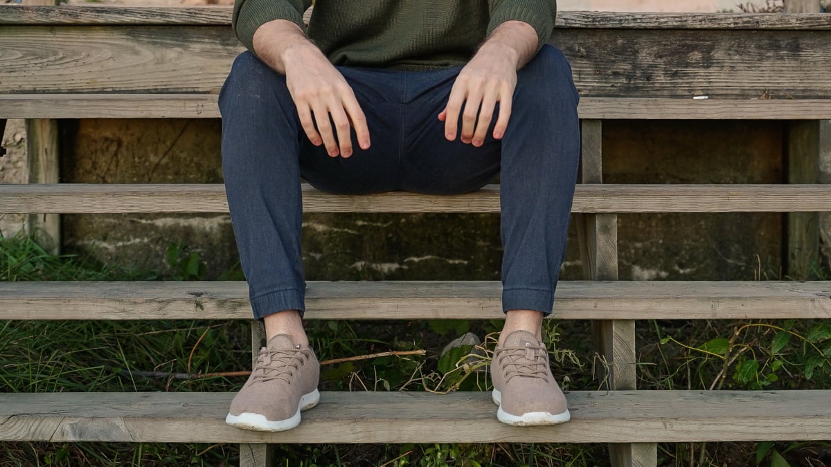 Types of Pants for Men Model Wearing Unbound Merino Joggers Sitting on Stairs